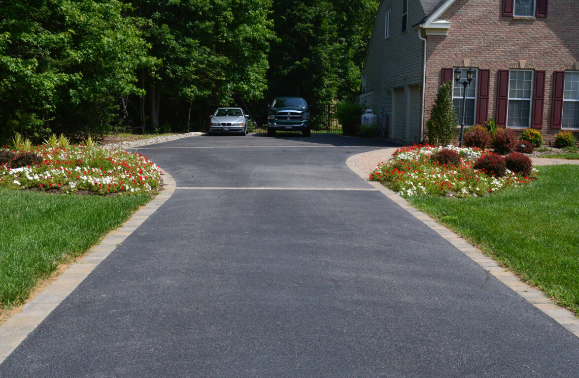 Professional concrete driveway with beautiful landscaping in Lowell, MA
